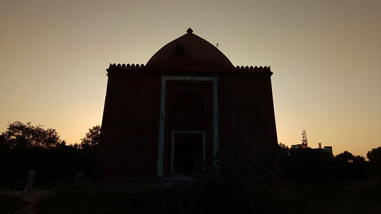 The sun sets over the Lal Gumbad